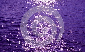 Pop art style purple colored sparkling water surface with the sea ripples