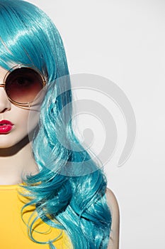 Pop art woman portrait wearing blue curly wig and sunglasses.