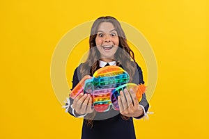 pop it fun. extremely happy child holding many color popit fidget.