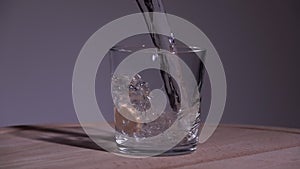 Pop tablet in water. Slow motion 250fps