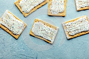 Pop tarts design. Poptart toaster pastry with icing on a blue slate background