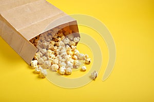 Popcorm paper bag on a yellow background
