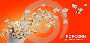 Popcorn in cardboard box, isolated on red background