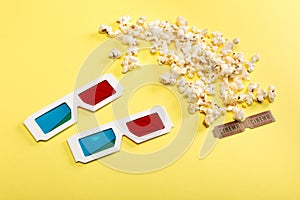 Popcorn, cinema tickets and 3D glasses on yellow, Movie time concept