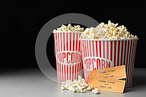 Popcorn and cinema tickets on table photo