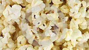 Popcorn corn, cooked, in bowl, rotation counterclockwise, turning macro close-up. Top view.