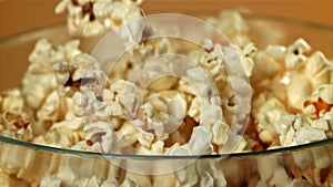 Popcorn drops into a big bowl. Filmed on a high-speed camera at 1000 fps.