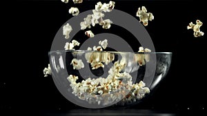 Popcorn drops into a big bowl. Filmed on a high-speed camera at 1000 fps.