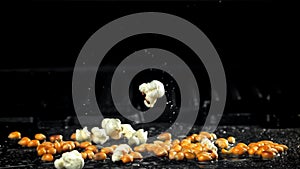 Popcorn explodes in a pan with a splash of oil. Filmed on a high-speed camera at 1000 fps.