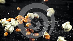 Popcorn explodes in a pan with a splash of oil. Filmed on a high-speed camera at 1000 fps.