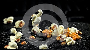 Popcorn explodes in a pan with a splash of oil. Filmed on a high-speed camera at 1000 fps.