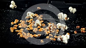 Popcorn explodes in a pan with a splash of oil. Filmed on a high-speed camera at 1000 fps.