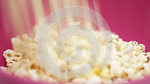 Popcorn falling in a plate