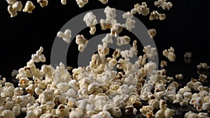 Popcorn falls on a black surface