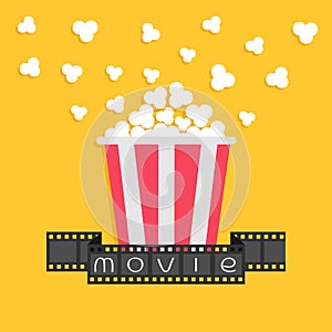 Popcorn. Film strip ribbon. Red yellow box. Cinema movie night icon in flat design style. Yellow background.