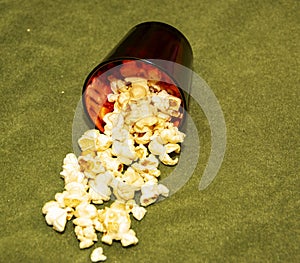 Popcorn in a glass on a green background.