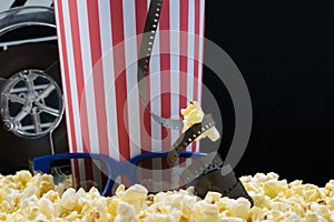 Popcorn and glasses for watching 3D movies on a black background