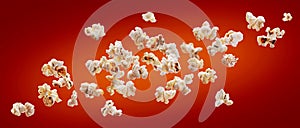 Popcorn isolated on red background. Falling or flying popcorn. Close-up