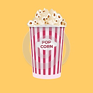 Popcorn isolated on a yellow background. A flat-style movie theater icon. A light snack. A large red and white striped