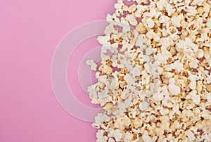 Popcorn on a pastel pink background and a place for text. Flat lay. Copyspace. Cinema Concept