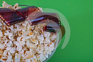 Popcorn, photo negative, on a green background, close-up Top view. Concept pastime