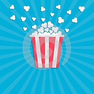 Popcorn popping. Cinema movie icon in flat design style. Red yellow strip box. Blue star burst wave background