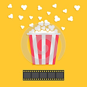 Popcorn popping. Film strip. Red yellow box. Cinema movie night icon in flat design style. Yellow background.