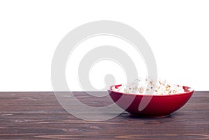 Popcorn in a pot on the table isolated on white background