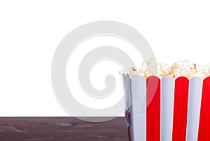 Popcorn in a pot on the table isolated on white background