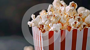Popcorn in a red and white box with a bokeh background.