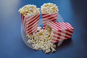 Popcorn in red and white container on a dark background