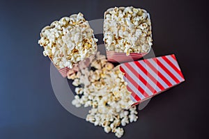 Popcorn in red and white container on a dark background