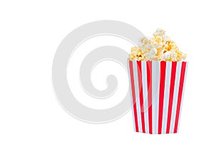 Popcorn in red and white striped cardboard bucket isolated on white background. Movie Popcorn isolated on white with clipping path