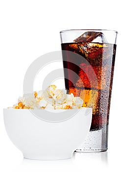 Popcorn salty sweet snack in white bowl with cola