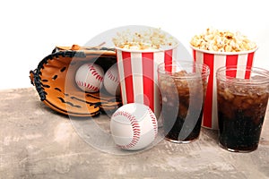 Popcorn on the table with softdrink cola. Baseball party food with balls for the playoffs