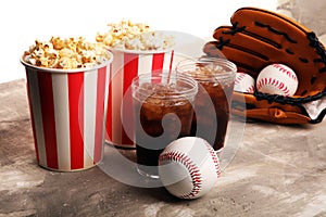 Popcorn on the table with softdrink cola. Baseball party food with balls for the playoffs