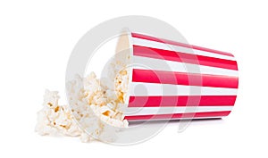 Popcorn was scattered from a large striped box, isolated on white background