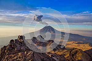 Popocatepetl volcano in Mexico, Tourist on the peak of high rocks. Sport and active life concept