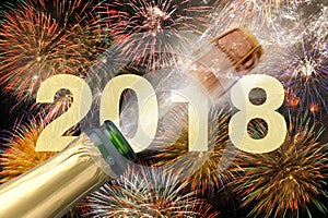 Popping champagne and fireworks at new years eve 2018