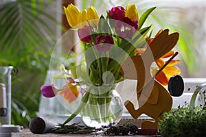 Poppy flowers on a glass jar on the table with other decors in a room