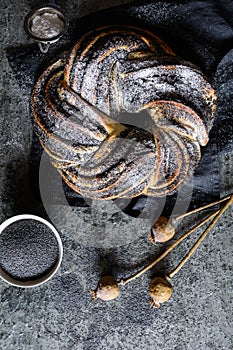 Poppy seed braid bread studded with powdered sugar