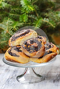 Poppy seed buns on cake stand. Christmas eve setting