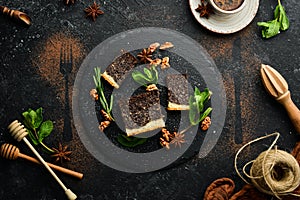 Poppy seed cake with chocolate and nuts. Dessert. On a black background. Top view