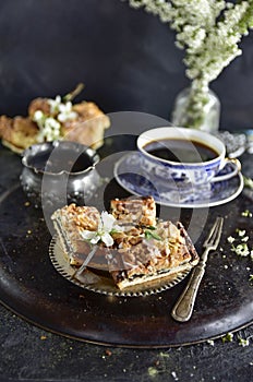 Poppy seed cake with morning coffee on a black background.