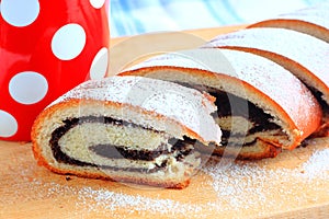 Poppy seed strudel and red cup with white polka dots