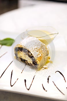 Poppy seeds and cream cheese strudel with custard and mint