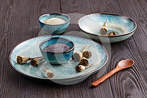 Poppy seeds and seedpods in ceramic bowl