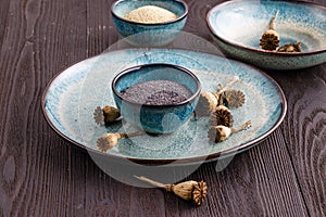 Poppy seeds and seedpods in ceramic bowl