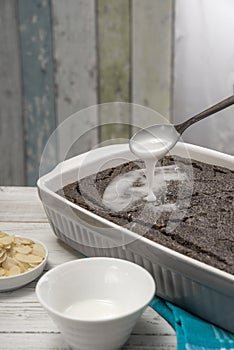 Poppyseed cake in a baking dish, sugar frosting