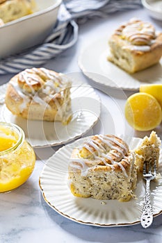 Poppyseed and lemon curd buns served on a plate